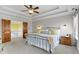 Relaxing main bedroom with trey ceiling, ceiling fan, and cozy decor at 9931 Woodlands Dr, Fishers, IN 46037