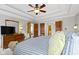 The bedroom features tray ceilings, ceiling fan, carpet floor, and neutral color palette at 9931 Woodlands Dr, Fishers, IN 46037