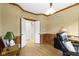 Open office area with hardwood floors and view of an open doorway into another room at 9931 Woodlands Dr, Fishers, IN 46037