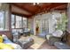 Cozy screened-in porch with comfortable seating, natural light, and peaceful outdoor views at 9931 Woodlands Dr, Fishers, IN 46037