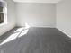 Bright, carpeted room featuring natural light with a large window and neutral walls at 10453 Apple Creek Dr, Indianapolis, IN 46235