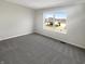 Neutral bedroom showcasing a large window and plush carpeting at 10453 Apple Creek Dr, Indianapolis, IN 46235