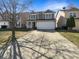 Charming two-story home with a well-manicured lawn and attached two-car garage at 10453 Apple Creek Dr, Indianapolis, IN 46235