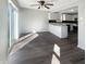 Bright kitchen featuring wood floors, a breakfast bar, white cabinets and stainless appliances at 10453 Apple Creek Dr, Indianapolis, IN 46235