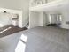 Open-concept living room with carpet, view of the kitchen, staircase and white trim at 10453 Apple Creek Dr, Indianapolis, IN 46235