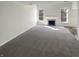 Spacious living room with fireplace, natural light, and neutral carpeting at 10453 Apple Creek Dr, Indianapolis, IN 46235
