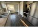 Galley-style kitchen with stainless steel appliances, wood floors, and updated cabinetry at 1124 Victory Ct, Anderson, IN 46016