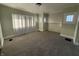 Bright living room featuring plush carpeting, ample natural light, and neutral paint tones at 1124 Victory Ct, Anderson, IN 46016