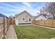 A backyard view shows a grass lawn and wood fence at 1331 N Grant Ave, Indianapolis, IN 46201