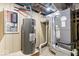 A basement view shows a water heater and furnace at 1331 N Grant Ave, Indianapolis, IN 46201