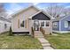 Charming bungalow with tidy landscaping, modern paint scheme and welcoming front steps at 1331 N Grant Ave, Indianapolis, IN 46201