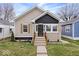 Charming bungalow with tidy landscaping, modern paint scheme and welcoming front steps at 1331 N Grant Ave, Indianapolis, IN 46201