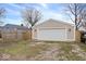 A backyard view shows a garage and gravel at 1331 N Grant Ave, Indianapolis, IN 46201