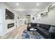 Open-concept living space with modern fireplace, comfortable seating, and open kitchen view at 1331 N Grant Ave, Indianapolis, IN 46201