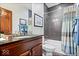 Cozy bathroom features dark wood cabinets, a granite countertop, and a shower and tub combo at 1529 N Alabama N St # B, Indianapolis, IN 46202