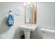 Stylish bathroom with pedestal sink, modern fixtures, and framed mirror at 1529 N Alabama N St # B, Indianapolis, IN 46202