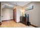 Hallway with wood floors, storage cabinet, and entry to other rooms at 1529 N Alabama N St # B, Indianapolis, IN 46202
