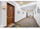 Hallway with neutral walls, unit doors, and an exit door to the exterior at 1529 N Alabama N St # B, Indianapolis, IN 46202