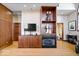 Cozy living room featuring a fireplace, built-in shelving, and warm wood accents at 1529 N Alabama N St # B, Indianapolis, IN 46202