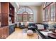 Cozy living room with hardwood floors, large arched windows, and stylish furniture arrangement at 1529 N Alabama N St # B, Indianapolis, IN 46202