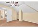 Cozy attic bedroom with angled ceilings, tan walls, ceiling fan and a closet at 1655 Cornell Ave, Indianapolis, IN 46202