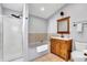 Bathroom features a tub and shower combination and wood cabinet vanity at 1655 Cornell Ave, Indianapolis, IN 46202