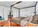 Bright bedroom showing open doors and hardwood floors underneath modern furnishings at 1655 Cornell Ave, Indianapolis, IN 46202