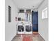 Bright laundry room featuring a washer and dryer, storage cabinets, and ample shelving for organization at 1655 Cornell Ave, Indianapolis, IN 46202