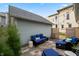 Cozy backyard patio with stylish blue outdoor furniture and string lights at 1665 N College Ave, Indianapolis, IN 46202