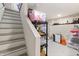 Basement storage with organized shelving, stairs, and painted concrete floor at 1665 N College Ave, Indianapolis, IN 46202
