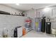 Basement area featuring a water heater, storage containers, and painted brick at 1665 N College Ave, Indianapolis, IN 46202