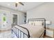 Bright bedroom with hardwood floors, a view to an outdoor deck and ensuite bathroom at 1665 N College Ave, Indianapolis, IN 46202