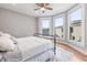 Cozy bedroom with hardwood floors, three windows, and a metal frame bed at 1665 N College Ave, Indianapolis, IN 46202