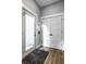Bright entryway with hardwood floors, shaker doors, and a glass-paneled front door at 1665 N College Ave, Indianapolis, IN 46202