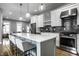 Modern kitchen with stainless appliances, a marble island, and a dark backsplash at 1665 N College Ave, Indianapolis, IN 46202