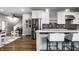 Modern kitchen with stainless steel appliances, white cabinets, and an open design, perfect for cooking and entertaining at 1665 N College Ave, Indianapolis, IN 46202