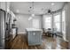 Bright kitchen with stainless steel appliances, marble island, and an adjacent dining area at 1665 N College Ave, Indianapolis, IN 46202