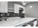 Bright, modern kitchen with white cabinets, marble countertops, and stainless steel appliances at 1665 N College Ave, Indianapolis, IN 46202