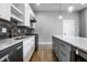 Modern kitchen featuring stainless appliances, marble countertops and an island with seating at 1665 N College Ave, Indianapolis, IN 46202