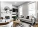 Bright living room with a fireplace, modern furnishings, and large windows for ample natural light at 1665 N College Ave, Indianapolis, IN 46202