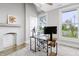Bright office space featuring modern desk, natural light, and a fireplace mantel at 1665 N College Ave, Indianapolis, IN 46202