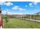 Fenced backyard with lush green grass and community walking path, offering a serene outdoor space at 2282 Creekland Dr, Columbus, IN 47201