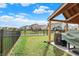 Well-maintained backyard featuring a black metal fence, lush green lawn and providing a secure outdoor space at 2282 Creekland Dr, Columbus, IN 47201