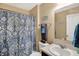 Well-lit bathroom featuring a vanity with a sink, toilet, and a shower with a decorative curtain at 2282 Creekland Dr, Columbus, IN 47201