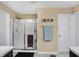 Bathroom with walk-in shower featuring glass doors and tiled walls, providing a clean, modern space at 2282 Creekland Dr, Columbus, IN 47201