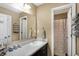 Bright bathroom featuring a vanity, sink, large mirror, and decorative towels and storage containers at 2282 Creekland Dr, Columbus, IN 47201