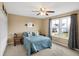 Cozy bedroom features a ceiling fan, ample natural light, and tasteful decor, creating a relaxing ambiance at 2282 Creekland Dr, Columbus, IN 47201