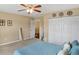 Bedroom with a ceiling fan, double closet and a door to the hallway, providing a convenient and comfortable space at 2282 Creekland Dr, Columbus, IN 47201