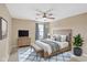 Comfortable bedroom with a wooden bed frame, TV on dresser, and a cozy blue rug at 2282 Creekland Dr, Columbus, IN 47201
