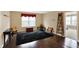 Bonus room has hardwood flooring, a window, and unique furniture pieces, creating a versatile living space at 2282 Creekland Dr, Columbus, IN 47201